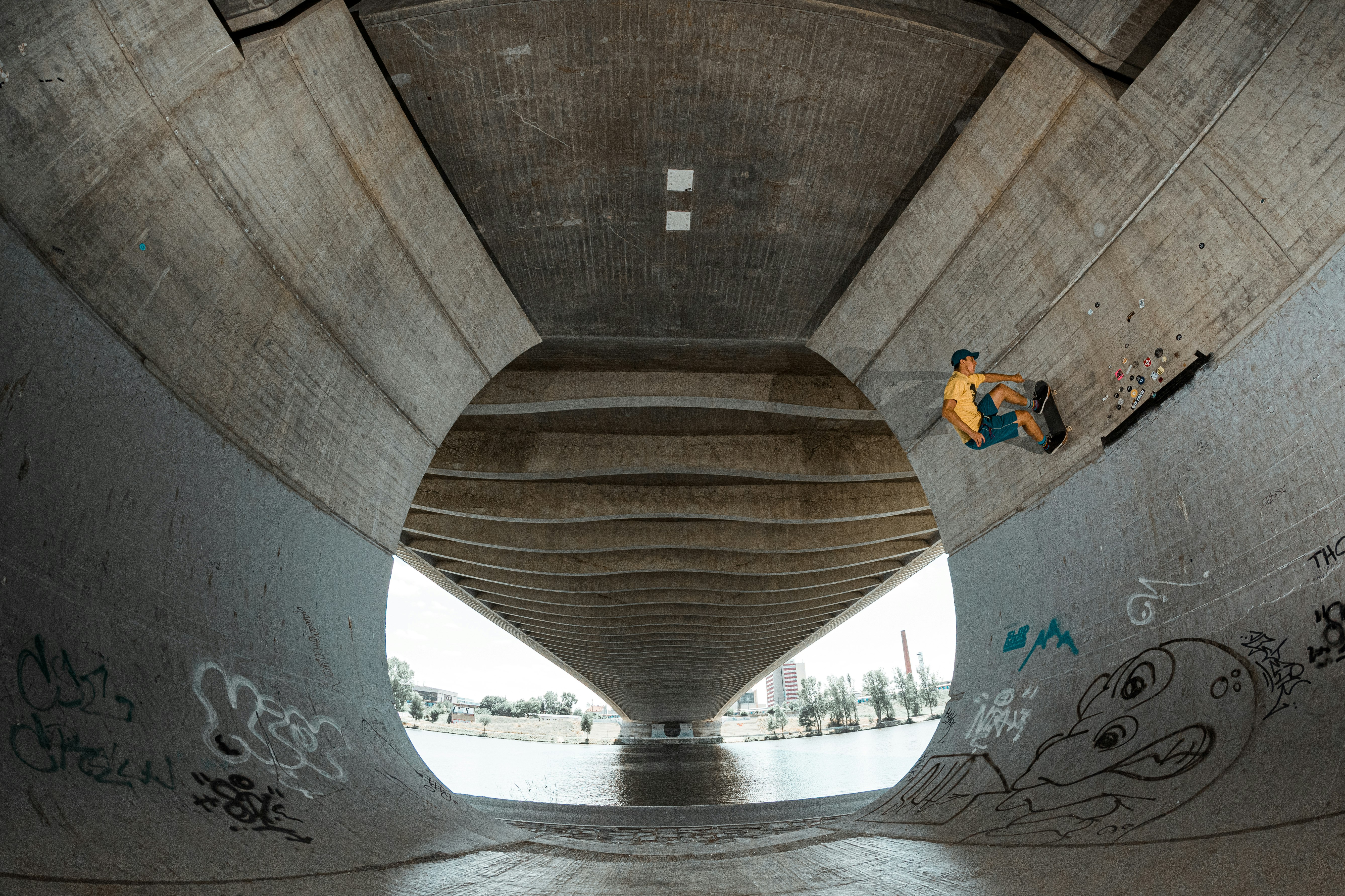 skateboarder under bridge